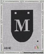 A taped needlepoint canvas with the design: Banner 18 mesh count Rounded M White on Black.