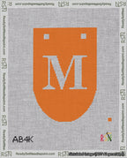 A taped needlepoint canvas with the design: Banner 18 mesh count Rounded M White on Orange.