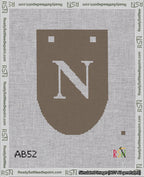A taped needlepoint canvas with the design: Banner 18 mesh count Rounded N White on Brown.