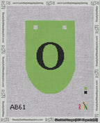 A taped needlepoint canvas with the design: Banner 18 mesh count Rounded O Black on Light Green.