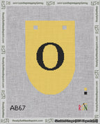 A taped needlepoint canvas with the design: Banner 18 mesh count Rounded O Black on Yellow.