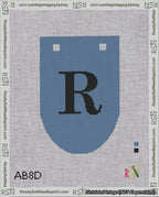A taped needlepoint canvas with the design: Banner 18 mesh count Rounded R Black on Blue.