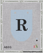 A taped needlepoint canvas with the design: Banner 18 mesh count Rounded R Black on Light Blue.