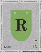 A taped needlepoint canvas with the design: Banner 18 mesh count Rounded R Black on Light Green.