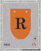 A taped needlepoint canvas with the design: Banner 18 mesh count Rounded R Black on Orange.