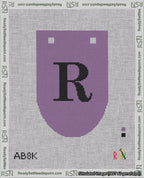 A taped needlepoint canvas with the design: Banner 18 mesh count Rounded R Black on Purple.