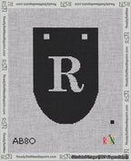 A taped needlepoint canvas with the design: Banner 18 mesh count Rounded R White on Black.