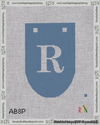 A taped needlepoint canvas with the design: Banner 18 mesh count Rounded R White on Blue.