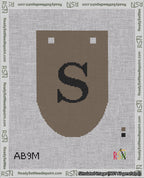 A taped needlepoint canvas with the design: Banner 18 mesh count Rounded S Black on Brown.