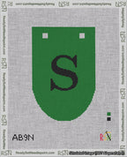A taped needlepoint canvas with the design: Banner 18 mesh count Rounded S Black on Green.