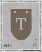 A taped needlepoint canvas with the design: Banner 18 mesh count Rounded T White on Brown.