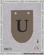 A taped needlepoint canvas with the design: Banner 18 mesh count Rounded U Black on Brown.