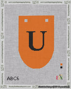 A taped needlepoint canvas with the design: Banner 18 mesh count Rounded U Black on Orange.