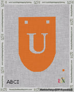 A taped needlepoint canvas with the design: Banner 18 mesh count Rounded U White on Orange.