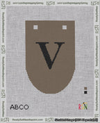A taped needlepoint canvas with the design: Banner 18 mesh count Rounded V Black on Brown.