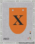 A taped needlepoint canvas with the design: Banner 18 mesh count Rounded X Black on Orange.