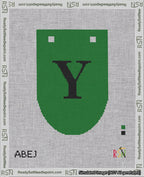 A taped needlepoint canvas with the design: Banner 18 mesh count Rounded Y Black on Green.