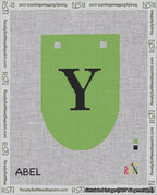 A taped needlepoint canvas with the design: Banner 18 mesh count Rounded Y Black on Light Green.