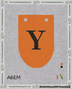 A taped needlepoint canvas with the design: Banner 18 mesh count Rounded Y Black on Orange.