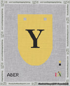 A taped needlepoint canvas with the design: Banner 18 mesh count Rounded Y Black on Yellow.