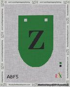 A taped needlepoint canvas with the design: Banner 18 mesh count Rounded Z Black on Green.