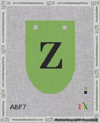 A taped needlepoint canvas with the design: Banner 18 mesh count Rounded Z Black on Light Green.
