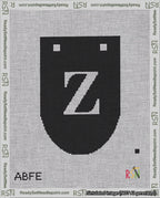 A taped needlepoint canvas with the design: Banner 18 mesh count Rounded Z White on Black.