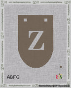 A taped needlepoint canvas with the design: Banner 18 mesh count Rounded Z White on Brown.