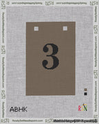A taped needlepoint canvas with the design: Banner 18 mesh count Squared 3 Black on Brown.