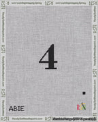 A taped needlepoint canvas with the design: Banner 18 mesh count Squared 4 Black on White.