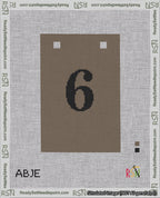 A taped needlepoint canvas with the design: Banner 18 mesh count Squared 6 Black on Brown.