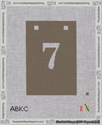 A taped needlepoint canvas with the design: Banner 18 mesh count Squared 7 White on Brown.
