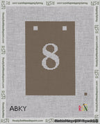 A taped needlepoint canvas with the design: Banner 18 mesh count Squared 8 White on Brown.