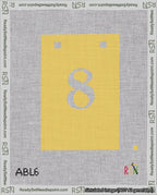 A taped needlepoint canvas with the design: Banner 18 mesh count Squared 8 White on Yellow.