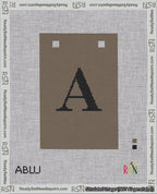 A taped needlepoint canvas with the design: Banner 18 mesh count Squared A Black on Brown.
