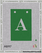 A taped needlepoint canvas with the design: Banner 18 mesh count Squared A White on Green.