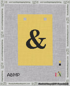 A taped needlepoint canvas with the design: Banner 18 mesh count Squared Ampersand Black on Yellow.
