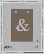 A taped needlepoint canvas with the design: Banner 18 mesh count Squared Ampersand White on Brown.