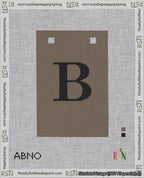 A taped needlepoint canvas with the design: Banner 18 mesh count Squared B Black on Brown.