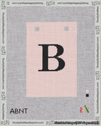 A taped needlepoint canvas with the design: Banner 18 mesh count Squared B Black on Pink.