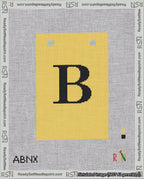 A taped needlepoint canvas with the design: Banner 18 mesh count Squared B Black on Yellow.