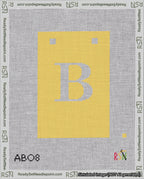 A taped needlepoint canvas with the design: Banner 18 mesh count Squared B White on Yellow.