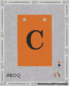 A taped needlepoint canvas with the design: Banner 18 mesh count Squared C Black on Orange.