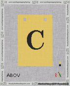 A taped needlepoint canvas with the design: Banner 18 mesh count Squared C Black on Yellow.