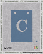 A taped needlepoint canvas with the design: Banner 18 mesh count Squared C White on Blue.