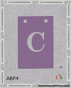A taped needlepoint canvas with the design: Banner 18 mesh count Squared C White on Purple.