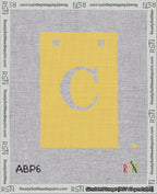 A taped needlepoint canvas with the design: Banner 18 mesh count Squared C White on Yellow.