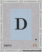 A taped needlepoint canvas with the design: Banner 18 mesh count Squared D Black on Light Blue.