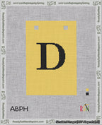 A taped needlepoint canvas with the design: Banner 18 mesh count Squared D Black on Yellow.