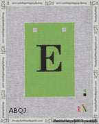 A taped needlepoint canvas with the design: Banner 18 mesh count Squared E Black on Light Green.